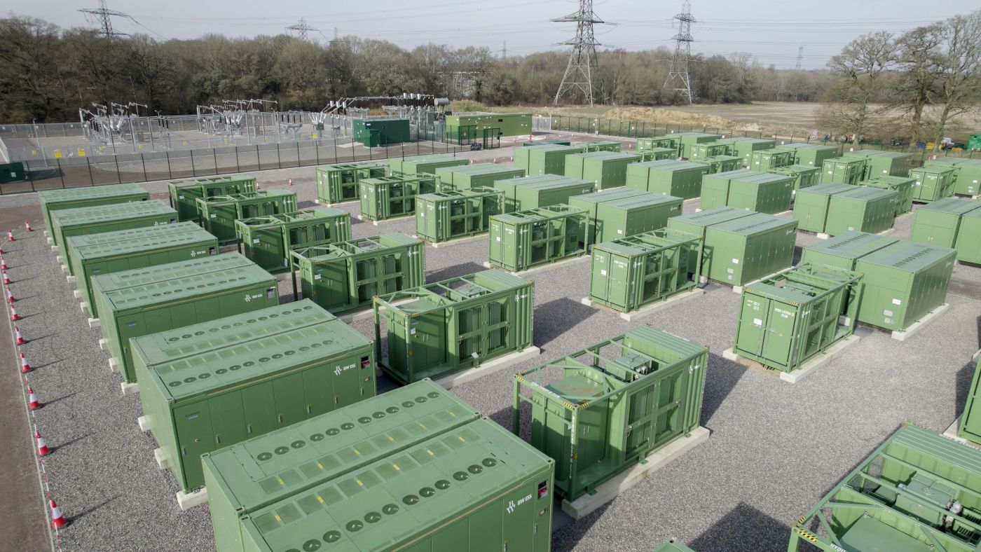 Aerial view of the Bramley BESS facility with green battery containers and a substation.