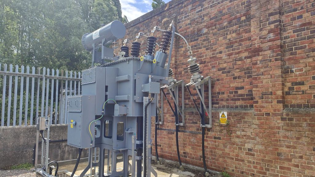 Ground-mounted distribution transformer at a UK DNO site.