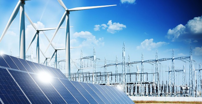 Solar panels and wind turbines integrated with grid substation infrastructure.