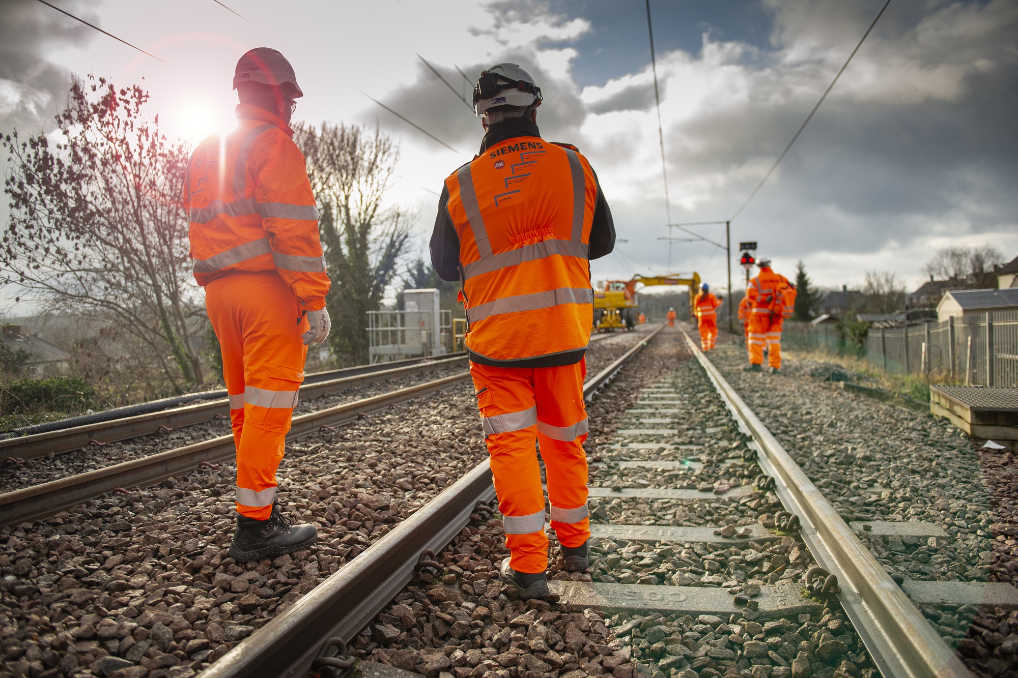 Network Rail engineers on track at dawn working on overhead line equipment.